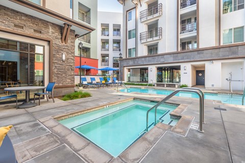 our apartments have a swimming pool and a patio with chairs and tables
